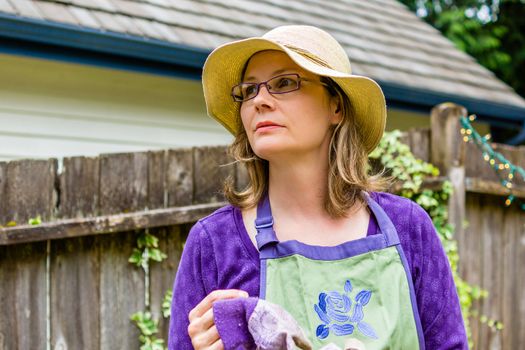 Pretty women gardening in her backyard.