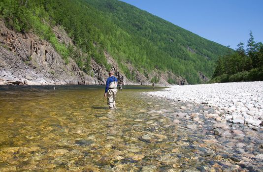 fisherman fishing on a mountain river in Siberia