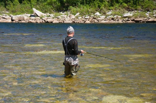 fisherman fishing on a mountain river in Siberia