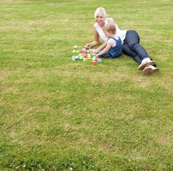 Family lying in the grass in the summer