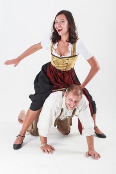 Bavarian couple in love with each other jokes in traditional costume
