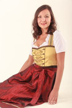 Bavarian beauty in costume sitting on the floor