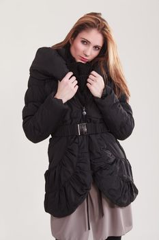 Young girl in a warm quilted jacket for winter