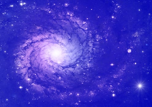 Spiral galaxy against blue space, nebula and stars in deep outer space