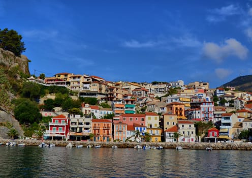 The bay coast with boats and houses under the bright sky