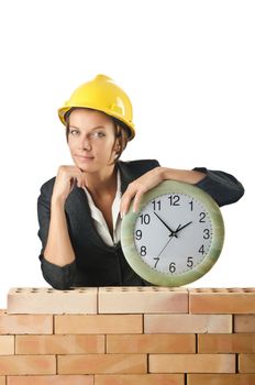 Female builder and clock on white