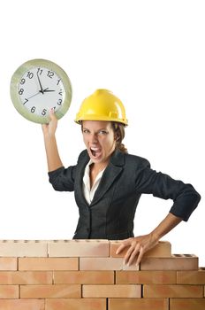 Female builder and clock on white