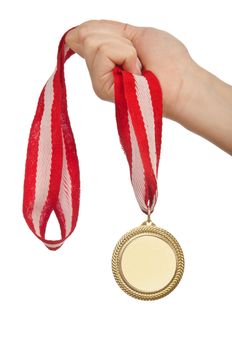 Hand holding gold medal on white