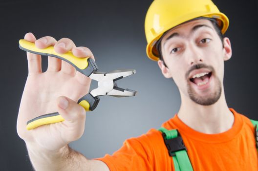 Man with tongs in studio