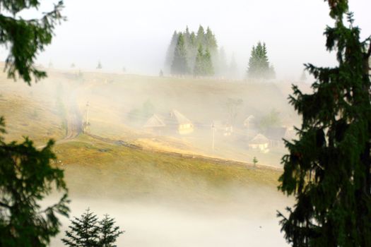 mountain village seen through the mist in the morning light