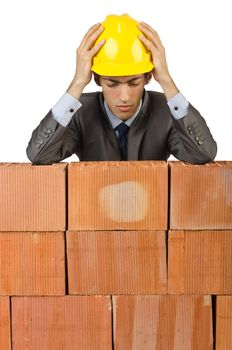 Businessman with bricks on white