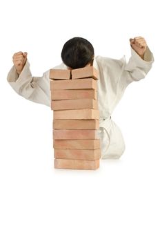 Karate man breaking bricks on white