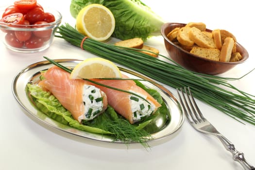 smoked salmon rolls with cream cheese, chives and a lemon slice