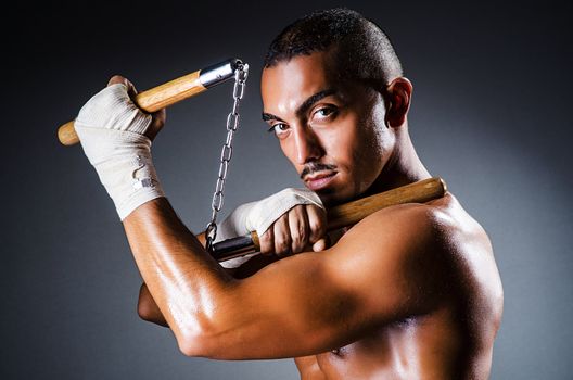 Strong man with nunchaku