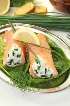 stuffed smoked salmon rolls with cream cheese, chives and a lemon slice