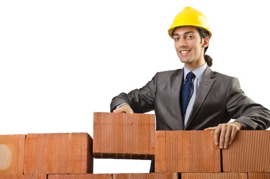 Businessman with bricks on white