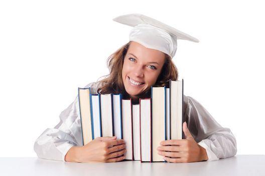 Happy graduate with lots of books on white