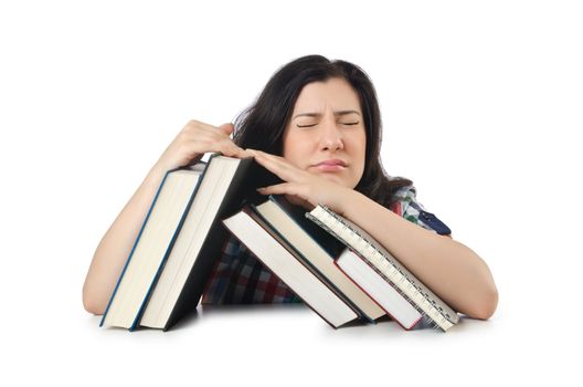 Tired student with textbooks on white