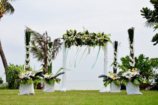 Floral arch for wedding ceremony beside the sea