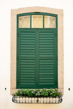 wooden green window with flower