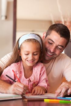 Delighted family drawing with colourful pen together a picture