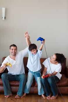 Young family celebrating and playing video games