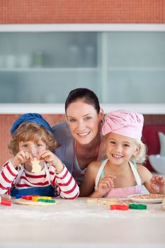 Enamoured mother with her two children in the kitchen