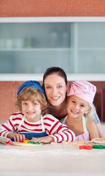 Portrait of a glowing family in the kitchen baking together