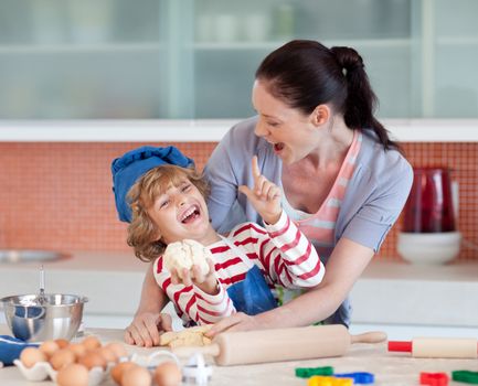 Laughing family having fun in the kitchen baking cookies