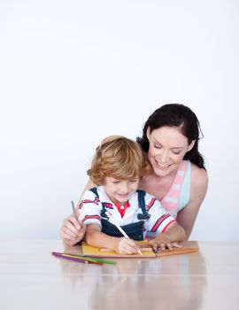 Young family draw a picture against white background