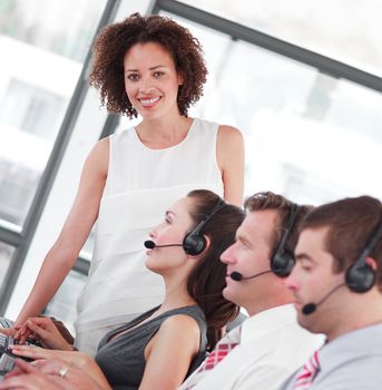 Smiling female manager with her sale representative team at work