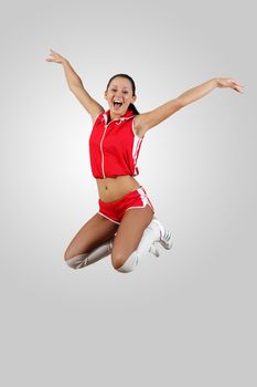 Young female dancer jumping against white background