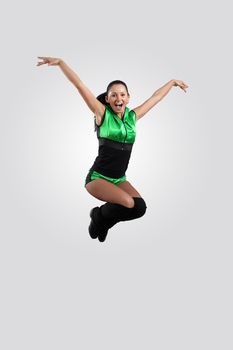 Young female dancer jumping against white background