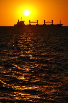 A silhouette of a boat at sunset in Montevideo, Uruguay.