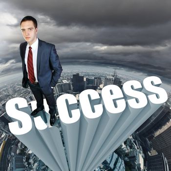 Businessman in suit standing on the word Success