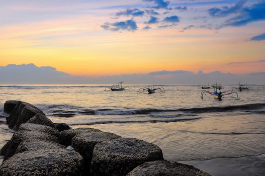 Ocean coast sunrise and fishing boats, Bali, Indonesia