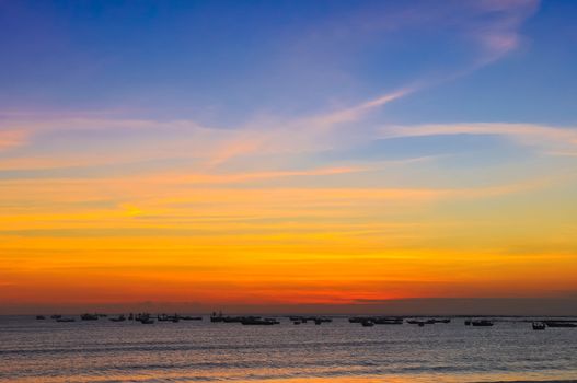 Ocean coast sunset and fishing boats, Bali, Indonesia