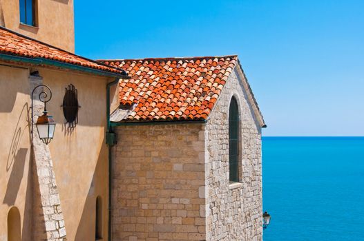 Historical building detail and ocean view with blue sky