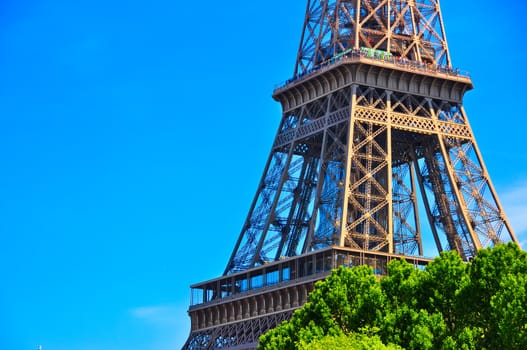 Eiffel tower detail view with blue sky background, Paris
