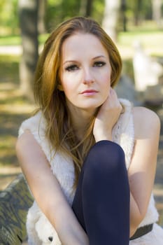 Young, beautiful woman in the city park