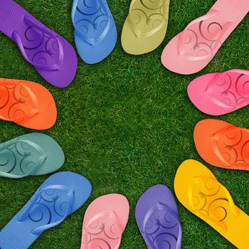 Colorful Flip Flops on green grass with copy space.
