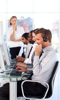 Concentrated female manager leading her representative team in a office