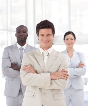 Serious male manager with his team in a office