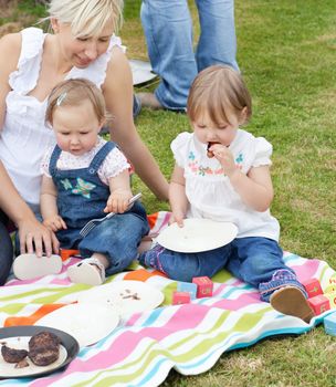 Smiling family having a picnic together in a park 
