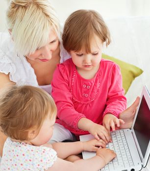 Cheerful family having fun with a laptop in the living-room at home