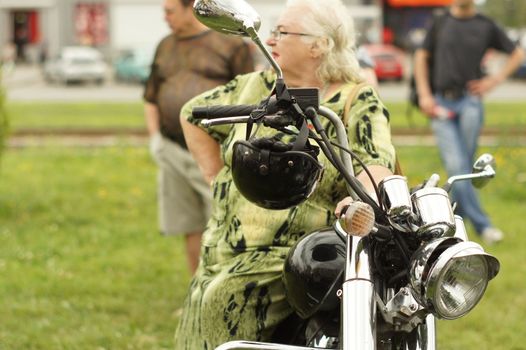 an elderly woman and a motorcycle