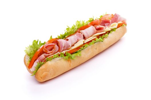 Big Sandwich on Long Baguette with Lettuce, Tomatoes, Cheese and Ham isolated on white background