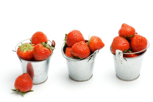 Tin Buckets with Ripe Strawberries in a Row isolated on white background