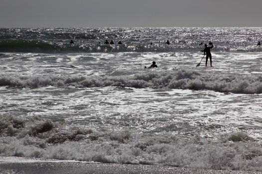 Surfers opening the season in Levanto, Italy.