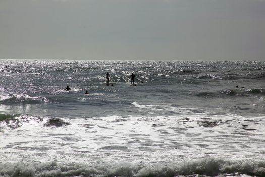 Surfers opening the season in Levanto, Italy.